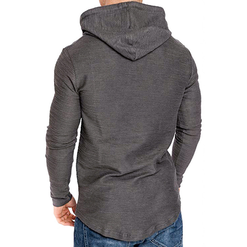 Athletic man wearing the Apex Core Hoodie featuring a slim fit, long sleeves, and a comfortable hooded design.