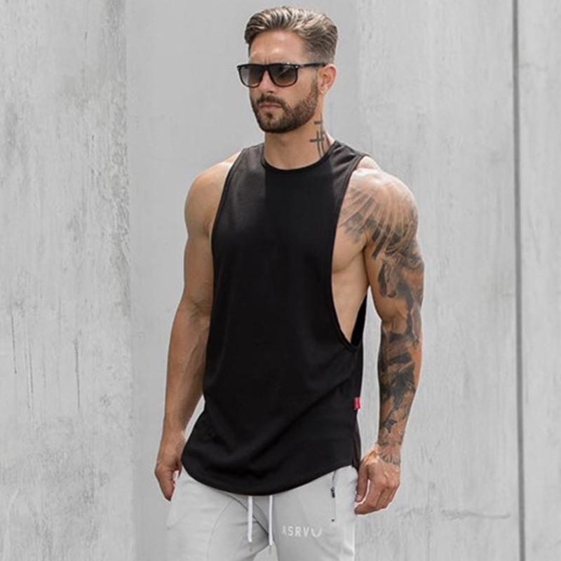 Athletic man wearing Apex Longline Muscle Tank during a workout, showcasing a modern longline fit and muscular physique.
