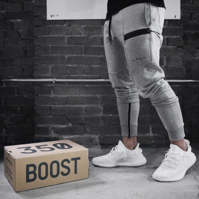 Man wearing Apex Utility Joggers featuring elastic waistband, ribbed cuffs, and secure utility pockets.